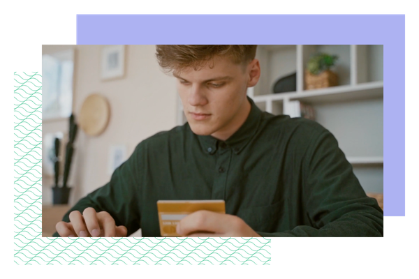 Young man using debit card for purchase